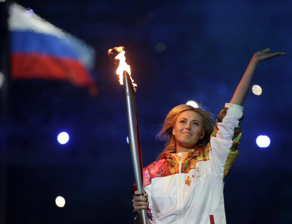 Russia's Maria Sharapova carries the torch during the opening ceremony of the 2014 Winter Olympics in Sochi, Russia, Friday, Feb. 7, 2014. (AP Photo/Matt Dunham)