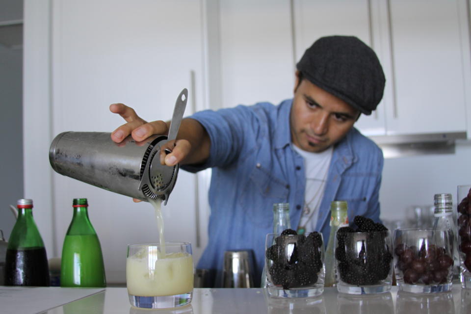 7. Using a strainer, pour the contents of the shaker into a glass filled with ice.