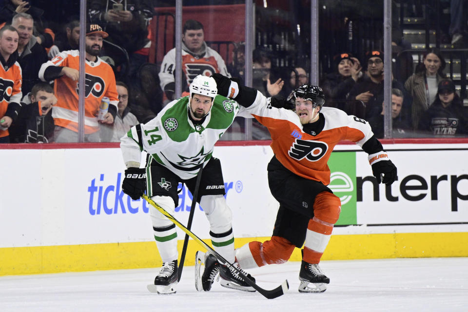 Dallas Stars' Jamie Benn, left, and Philadelphia Flyers' Travis Sanheim tangle during a play in the second period of an NHL hockey game Thursday, Jan. 18, 2024, in Philadelphia. (AP Photo/Derik Hamilton)