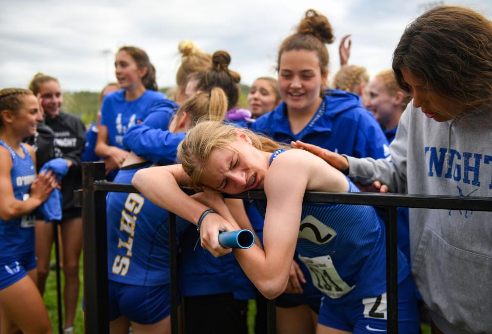 O'Gorman's Mahli Abdouch collapses onto a fence while her team celebrates behind her after the 4x400 meter relay at the class AA State track and field meet on Saturday, May 29, at Woodle Field in Sturgis, South Dakota. A .01 second difference in that final race left O'Gorman and Brandon Valley tied for the team title with 124 points apiece. 