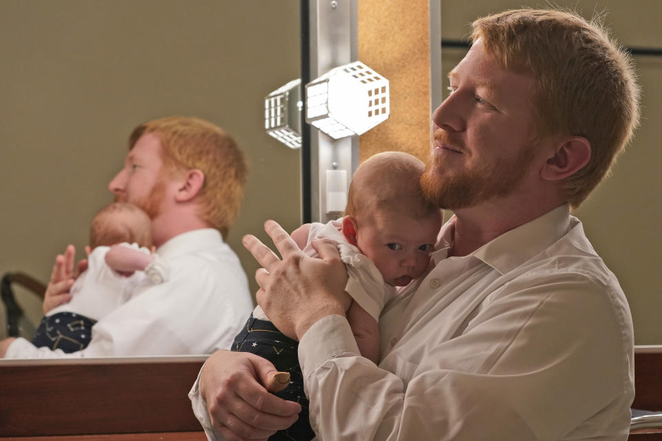 Democratic gubernatorial candidate, Del. Lee Carter, D-Manassas, holds his baby girl, Charlotte, during an interview prior to the last primary debate in Newport News, Va., Tuesday, June 1, 2021. Carter faces four other Democrats in the primary June 8. (AP Photo/Steve Helber)