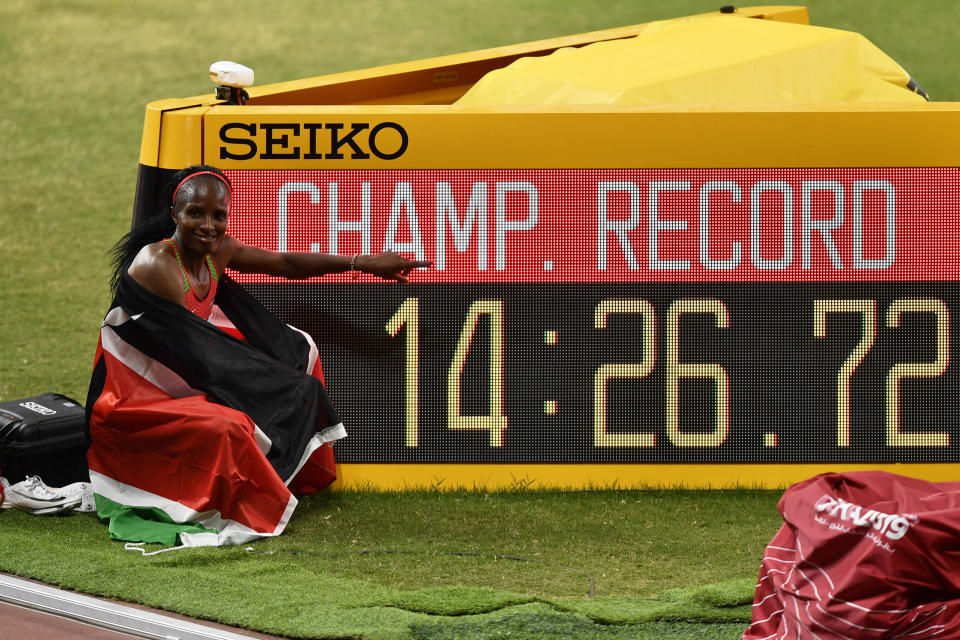 Hellen Obiri, of Kenya poses after winning the women's 5000 meter final setting a new championship record during the World Athletics Championships in Doha, Qatar, Saturday, Oct. 5, 2019. (AP Photo/Martin Meissner)