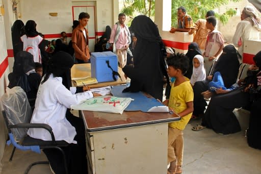 Displaced Yemenis who fled battles in Hodeida wait for a medical check in the northern district of Abs