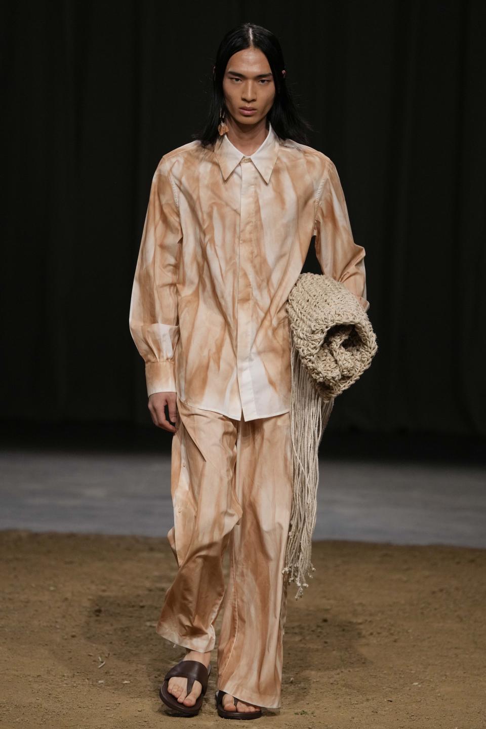 A model wears a creation as part of the Federico Cina men's Spring Summer 2024 collection presented in Milan, Italy, Saturday, June 17, 2023. (AP Photo/Luca Bruno)