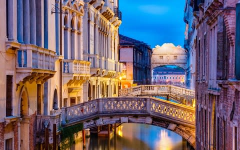 Bridges over the Rio di Palazzo canal with the Bridge of Sighs in the background - Credit: Getty