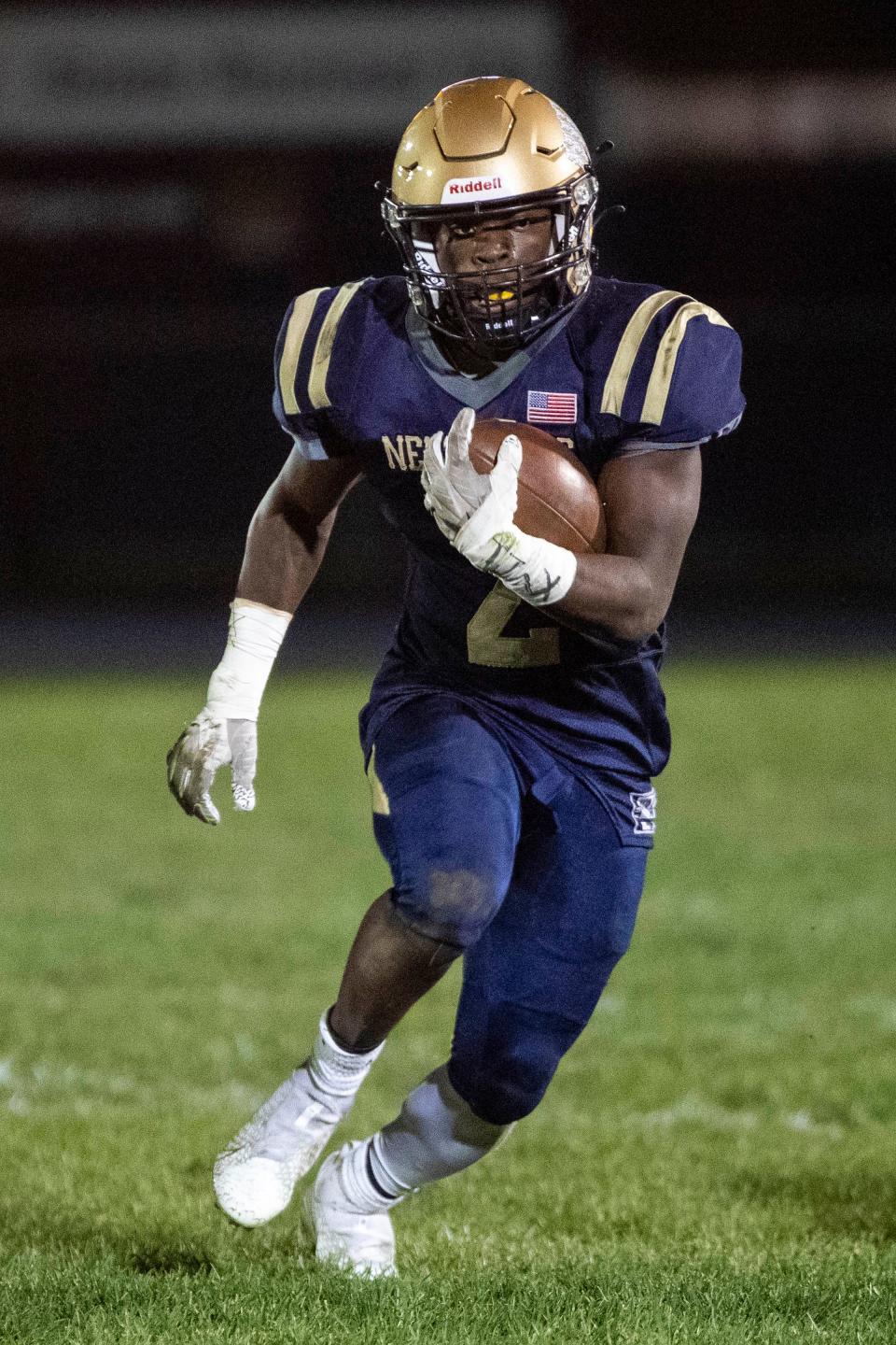 New Prairie's Noah Mungia (2) runs with the ball for yardage during the Elkhart-New Prairie high school football game on Friday, October 14, 2022, at Amzie Miller Field in New Carlisle, Indiana.