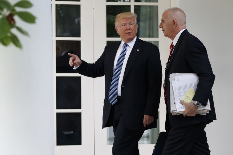 EDITORS NOTE: Information masked by blur for privacy. President Trump walks with aide Keith Schiller to the Oval Office, May 2, 2017. (Photo: Evan Vucci/AP)