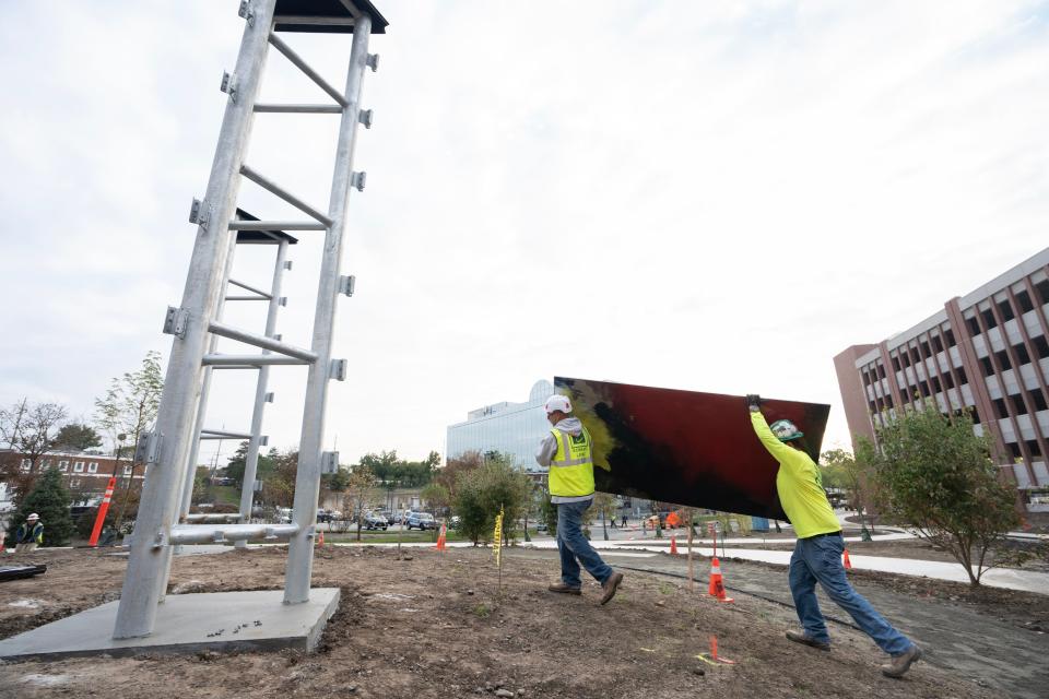 Carpenters for Edward Leske Company install the panels of the Stefan Knapp mural in the courtyard of the of new Valley Hospital in Paramus, NJ on Wednesday Oct. 11, 2023.
