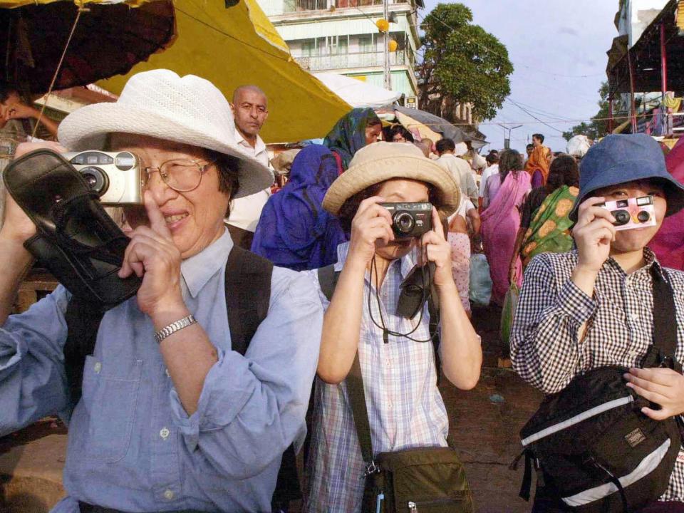 Tourists take photos of Varanasi in 2001.