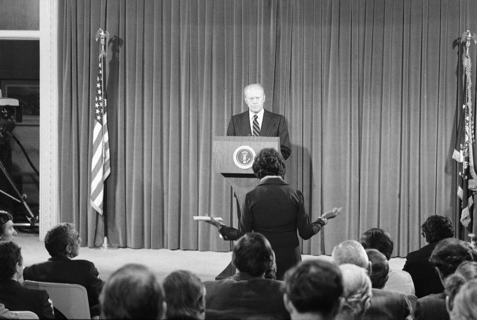 FILE - In this Oct. 9, 1975, file photo President Gerald Ford listens to a news reporter's question during a news conference at the Executive Office building in Washington. It was Ford's first live nationally broadcast news conference since June 24. (AP Photo, File)