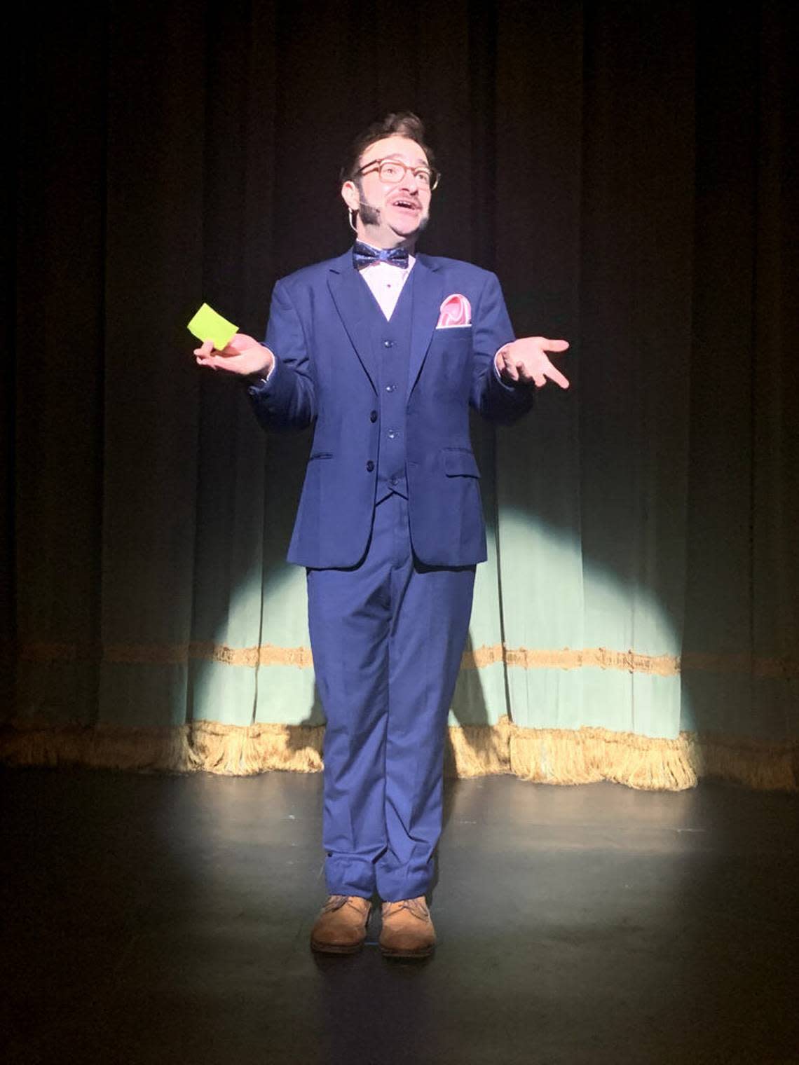 Kalen Edean welcomes the audience as Christopher Bean in Loxen Entertainment’s production of “The Play That Goes Wrong” at the Colony Theatre on Lincoln Road, Miami Beach.