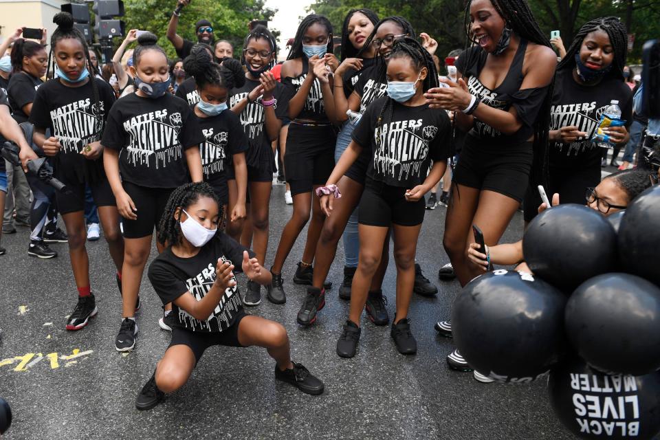 Kids dance on 16th Street Northwest renamed Black Lives Matter Plaza near the White House in Washington, Friday, June 19, 2020, to mark Juneteenth. The holiday celebrates the day in 1865 that enslaved Black people in Galveston, Texas, learned they had been freed from bondage, more than two years after the Emancipation Proclamation.