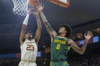 Texas forward Dillon Mitchell (23) and Baylor forward Jalen Bridges (11) reach for a rebound during the first half of an NCAA college basketball game Monday, Jan. 30, 2023, in Austin, Texas. (AP Photo/Stephen Spillman)