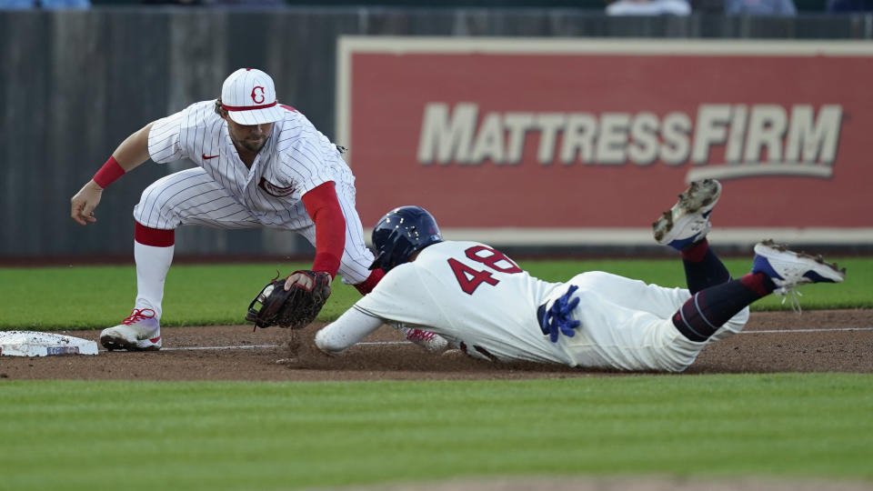 Cincinnati Reds third baseman Kyle Farmer tags Chicago Cubs' P.J. Higgins (48) in the fourth inning during a baseball game at the Field of Dreams movie site, Thursday, Aug. 11, 2022, in Dyersville, Iowa. (AP Photo/Charlie Neibergall)