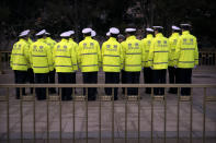 Chinese police gather outside the Great Hall of the People, ahead of the opening session of China's National People's Congress (NPC) in Beijing, Tuesday, March 5, 2019. A year since removing any legal barrier to remaining China's leader for life, Xi Jinping appears firmly in charge, despite a slowing economy, an ongoing trade war with the U.S. and rumbles of discontent over his concentration of power. (AP Photo/Mark Schiefelbein)