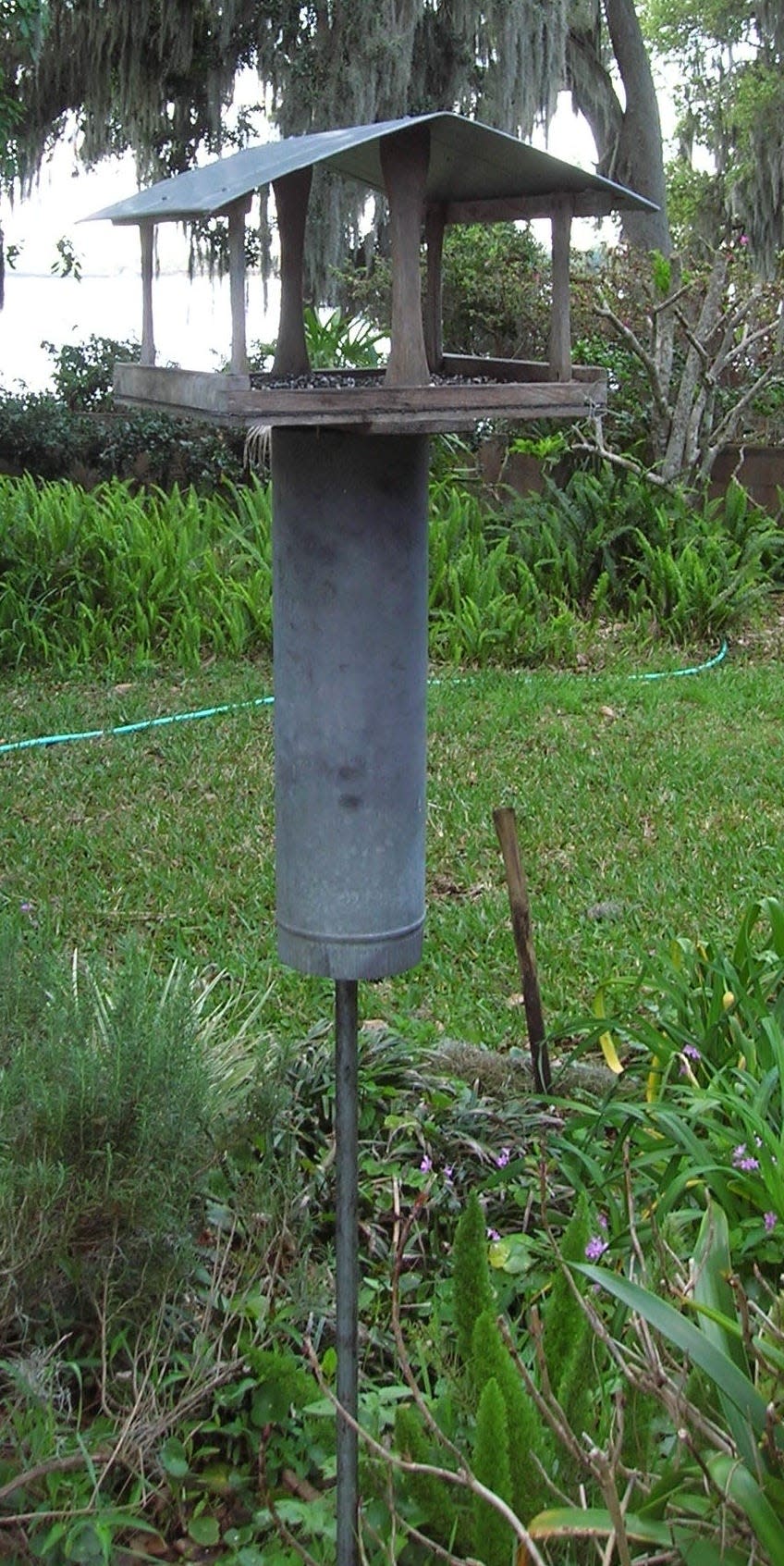 Simple, cheap and 100% effective — all it takes is a length of chimney pipe to squirrel-proof the bird feeder.