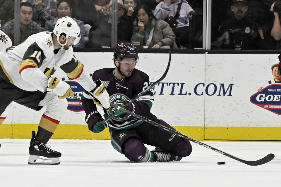 Anaheim Ducks center Mason McTavish, right, vies for the puck against Vegas Golden Knights center Nicolas Roy during the second period of an NHL hockey game in Anaheim, Calif., Wednesday, Dec. 27, 2023. (AP Photo/Alex Gallardo)