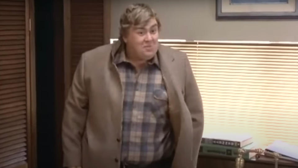 John Candy smiles while standing in an office in Splash.