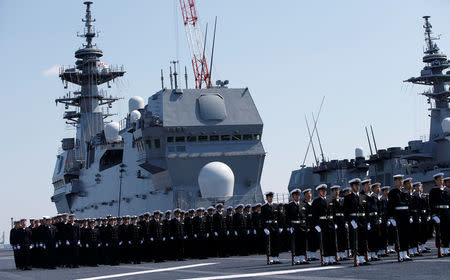 Members of the Japan Maritime Self-Defense Force (JMSDF) attend a handover ceremony for the JMSDF's latest Izumo-class helicopter carrier DDH-184 Kaga by Japan Marine United Corporation in Yokohama, Japan March 22, 2017. REUTERS/Toru Hanai