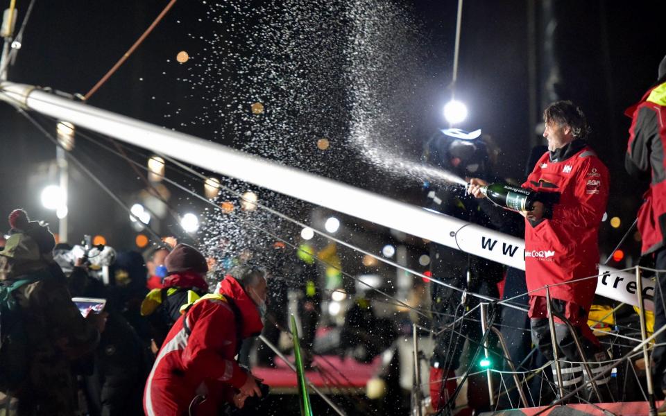 French skipper Yannick Bestaven celebrates and sprays champagne after crossing the finish line - FRANCK CASTEL/EPA-EFE/Shutterstock /Shutterstock