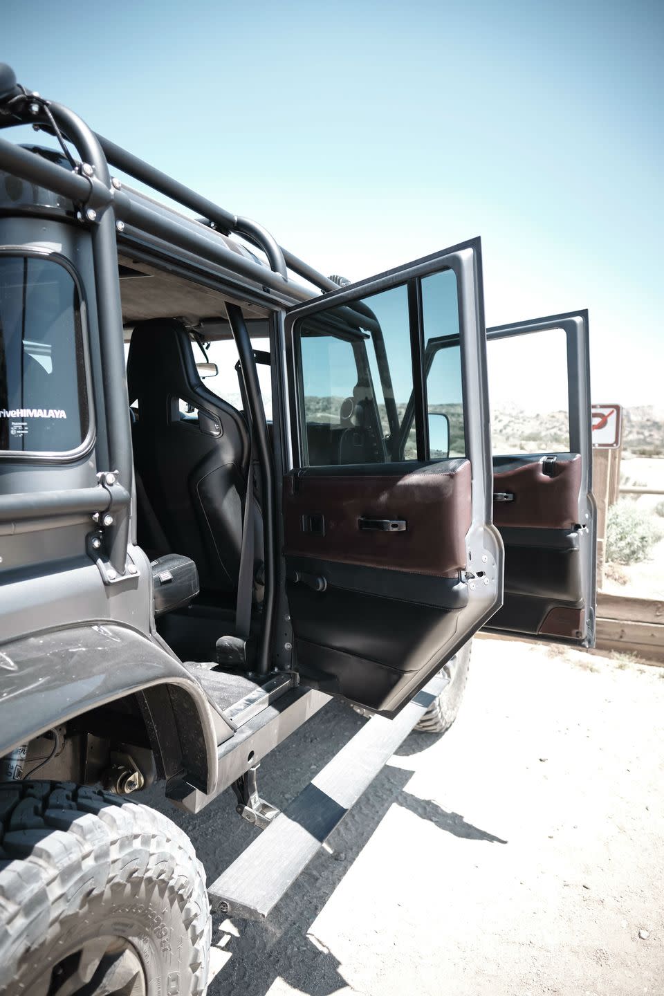 <p>If there's one area of this build that the team seems to be most proud of, it's the improvement in the level of fit and finish on the bodywork. It's easy to see that the doors align and close better than on any stock Defender. A stock door might require a slam to have it shut properly. But the Himalaya doors close easily with an easy click.</p><p>They're satisfyingly heavy, too. Himalaya says its doors weigh quite a bit more than the stock door thanks to multiple layers of sound insulation. They are so heavy, the team had to upgrade the hinges and mechanisms.</p><p>"We've actually changed the latch on the body side, too, so that it doesn't catch clothing anymore," says director of operations Arthur Lekic. "It's not something you really notice until you've ripped your favorite pair of jeans."</p><p>The door sealing and the upgraded sound deadening all around the vehicle do a good job of muffling road noise.</p>