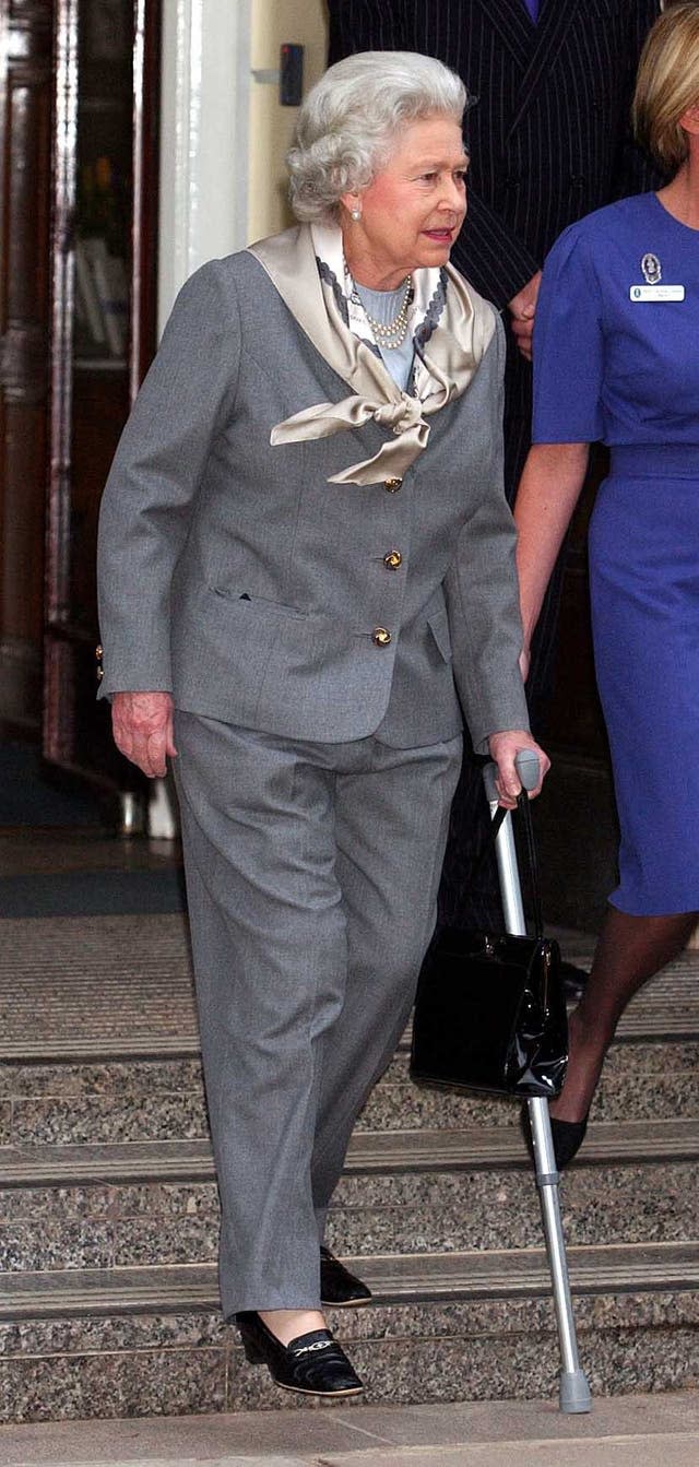 The Queen walks with a stick after leaving hospital