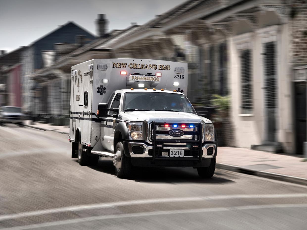 A New Orleans ambulance drives in the French Quarter