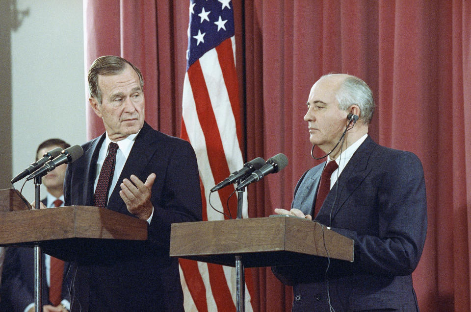 FILE - In this Oct. 29, 1991, file photo, President George H.W. Bush gestures during a joint news conference with Soviet President Mikhail Gorbachev, at the Soviet Embassy in Madrid. Bush died at the age of 94 on Friday, Nov. 30, 2018, about eight months after the death of his wife, Barbara Bush. (AP Photo/Jerome Delay, File)