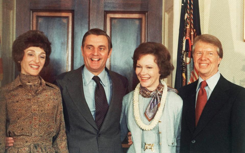 Jimmy Carter, right, and Rosalynn Carter, second from right, pose with Vice President Walter Mondale and wife, Joan Mondale, - AP