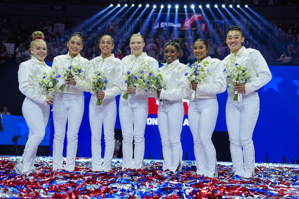 From left to right, Joscelyn Roberson, Suni Lee, Hezly Rivera, Jade Carey, Simone Biles, Jordan Chiles and Leanne Wong smile after they were named to the 2024 Olympic team at the United States Gymnastics Olympic Trials on Sunday, June 30, 2024, in Minneapolis. (AP Photo/Charlie Riedel)