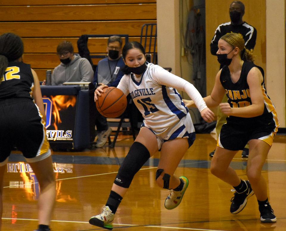 Dolgeville Blue Devil Kerisa Van Olst (15) works her way between Canajoharie defenders Kaijah Fowler (left) and Felise Fowler during the first half of Saturday's game.