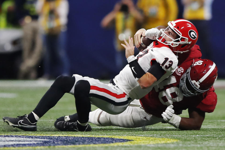 Georgia QB Stetson Bennett is sacked by Alabama's Phidarian Mathis during the third quarter of the SEC title game on Dec. 4. (Todd Kirkland/Getty Images)