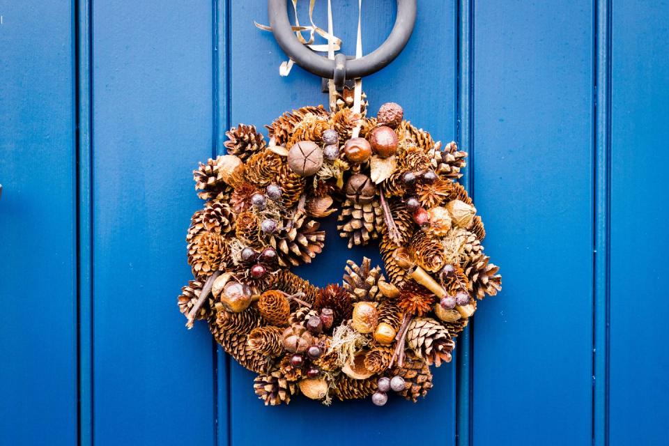 <p>This DIY wreath can take you easily from fall to winter. Just add an orange or black bow for fall, and a velvet/plaid bow for winter. </p><p><em><strong><a href="https://www.youtube.com/watch?v=H1bx0TCDxQU" rel="nofollow noopener" target="_blank" data-ylk="slk:Get the tutorial for Pine Cone Wreath on Flower Lab.;elm:context_link;itc:0;sec:content-canvas" class="link ">Get the tutorial for Pine Cone Wreath on Flower Lab.</a></strong></em></p>