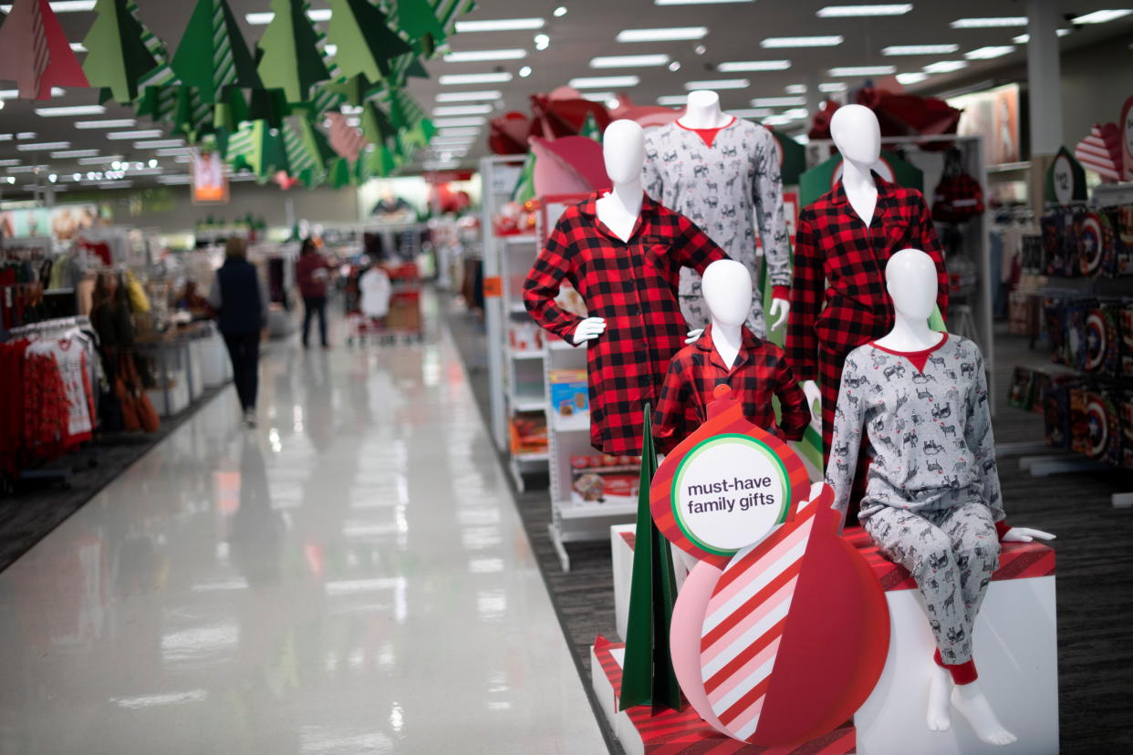 Shoppers browse merchandise beside a Target store decorated for the winter holidays in King of Prussia, Pennsylvania U.S. November 20, 2020. REUTERS/Mark Makela