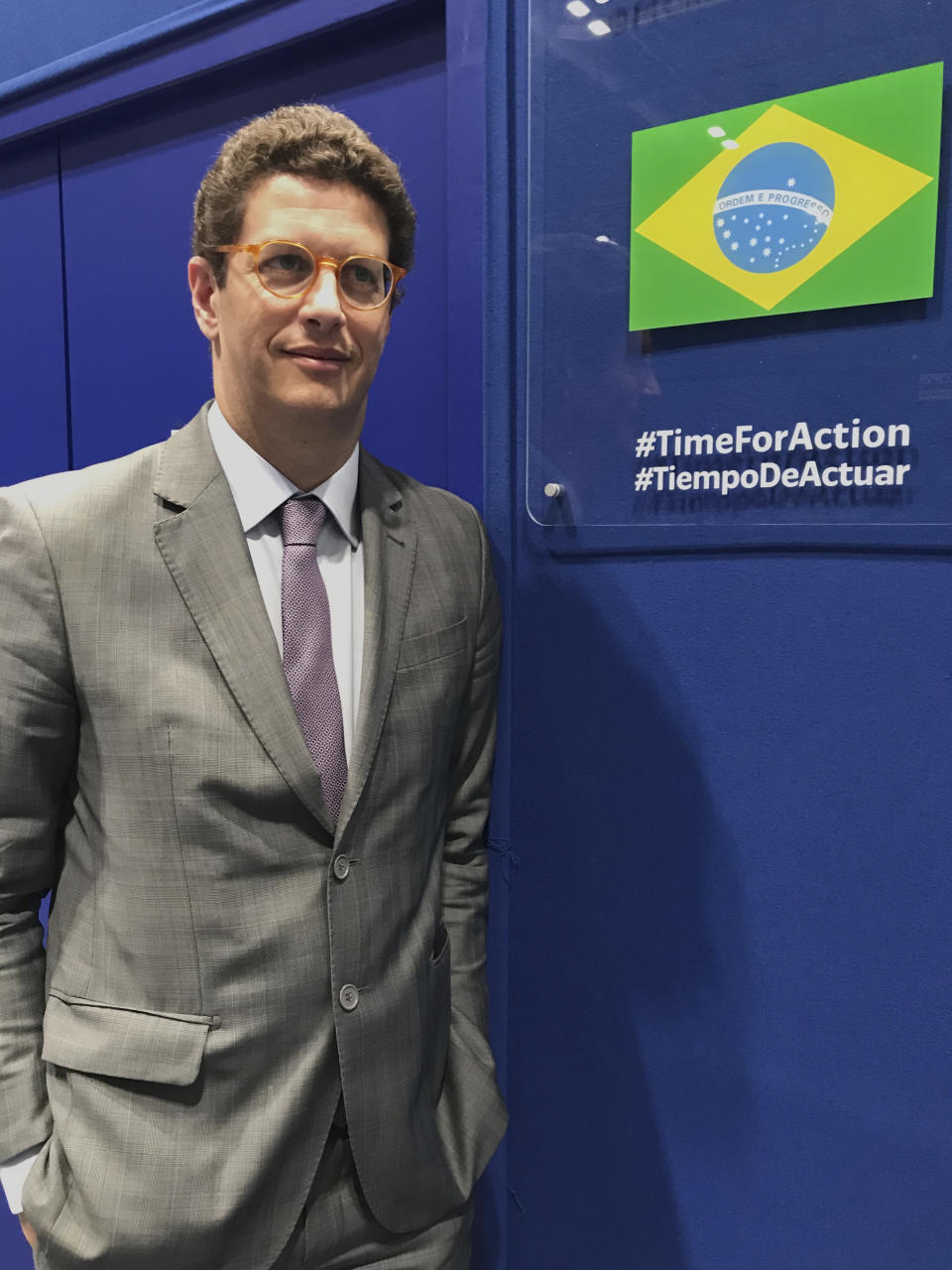 In this photo taken on Saturday Dec. 7, 2019, Brazilian environment Ricardo Salles stands outside the Brazil delegation room at the COP25 U.N. climate talks in Madrid, Spain. Madrid is hosting a two-week global summit aimed at lessening the impact of rising temperatures. (AP Photo/Dorothee Thiesing)