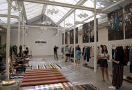 Attendees look at creations from the Missoni men's Spring-Summer 2020 collection, at a presentation during the fashion week, in Milan, Italy, Sunday, June 16, 2019. (AP Photo/Luca Bruno)