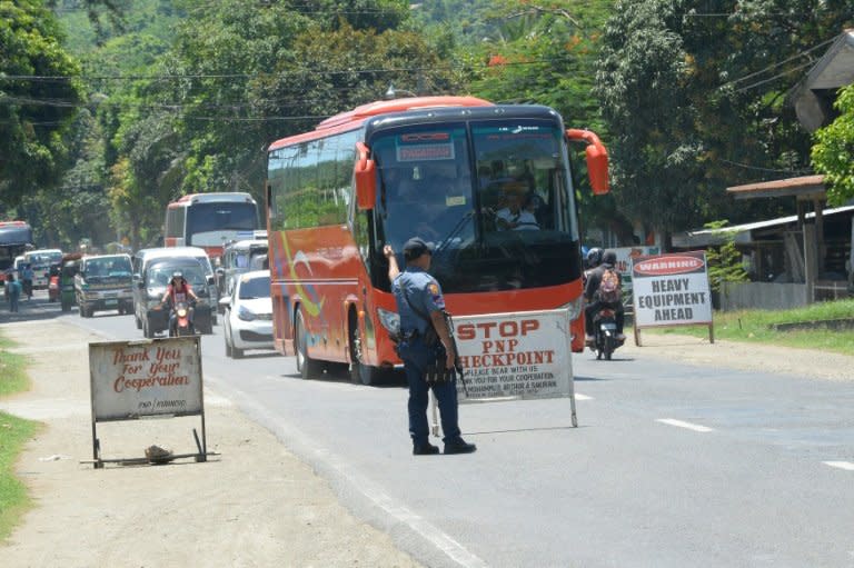 A Philippine policeman mans a checkpoint along a highway in Iligan City, in southern island of Mindanao on May 24, 2017