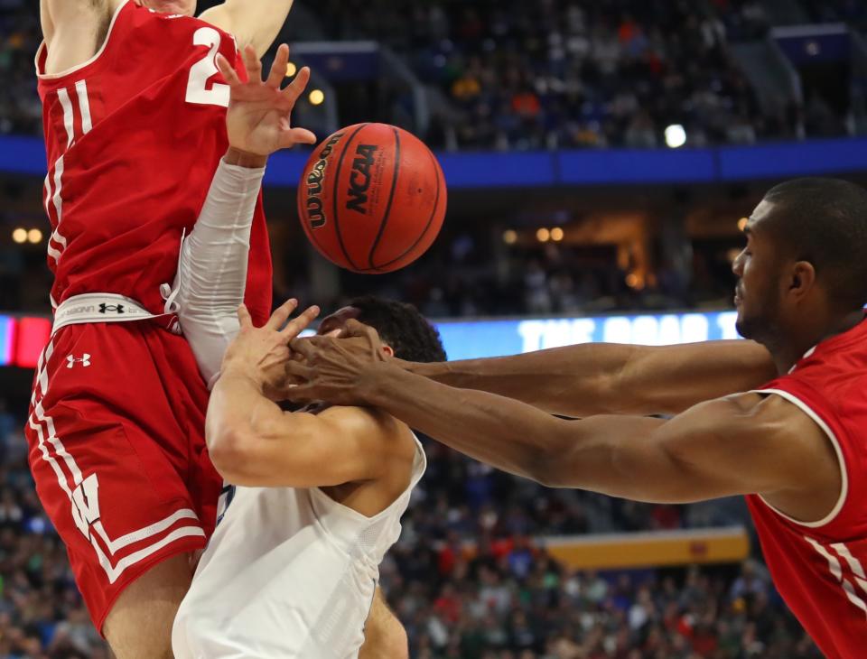 <p>Villanova guard Josh Hart (3) drives to the basket against Wisconsin forward Ethan Happ (22) and forward Vitto Brown (30) with three seconds remaining in the second half of a second-round men’s college basketball game in the NCAA Tournament, Saturday, March 18, 2017, in Buffalo, N.Y. A Villanova foul was called on the play and Wisconsin won, 65-62. (AP Photo/Bill Wippert) </p>