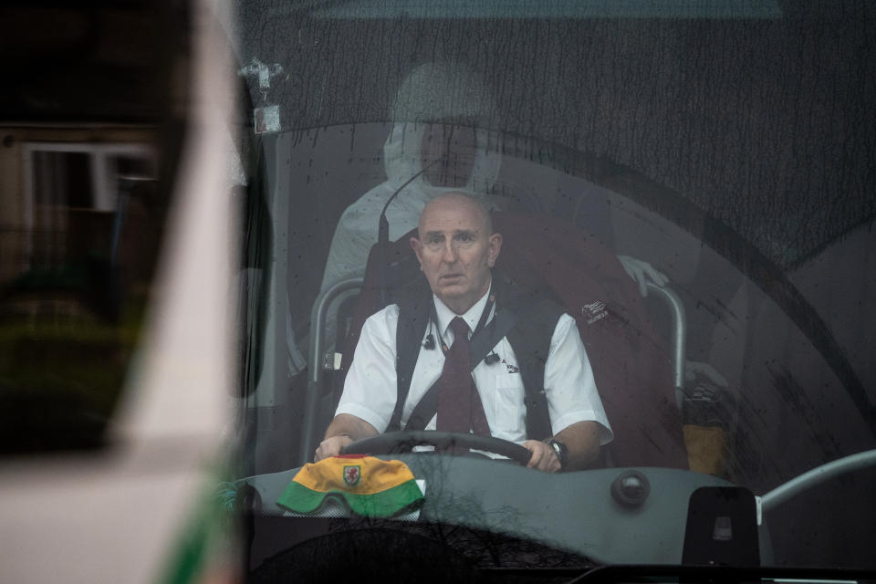 A man in protective clothing sits behind the driver in one of the coaches transporting eighty-three Britons and 27 foreign nationals who have been evacuated from Wuhan following a Coronavirus outbreak, from RAF Brize Norton to Arrowe Park Hospital in Merseyside, where they will be quarantined.