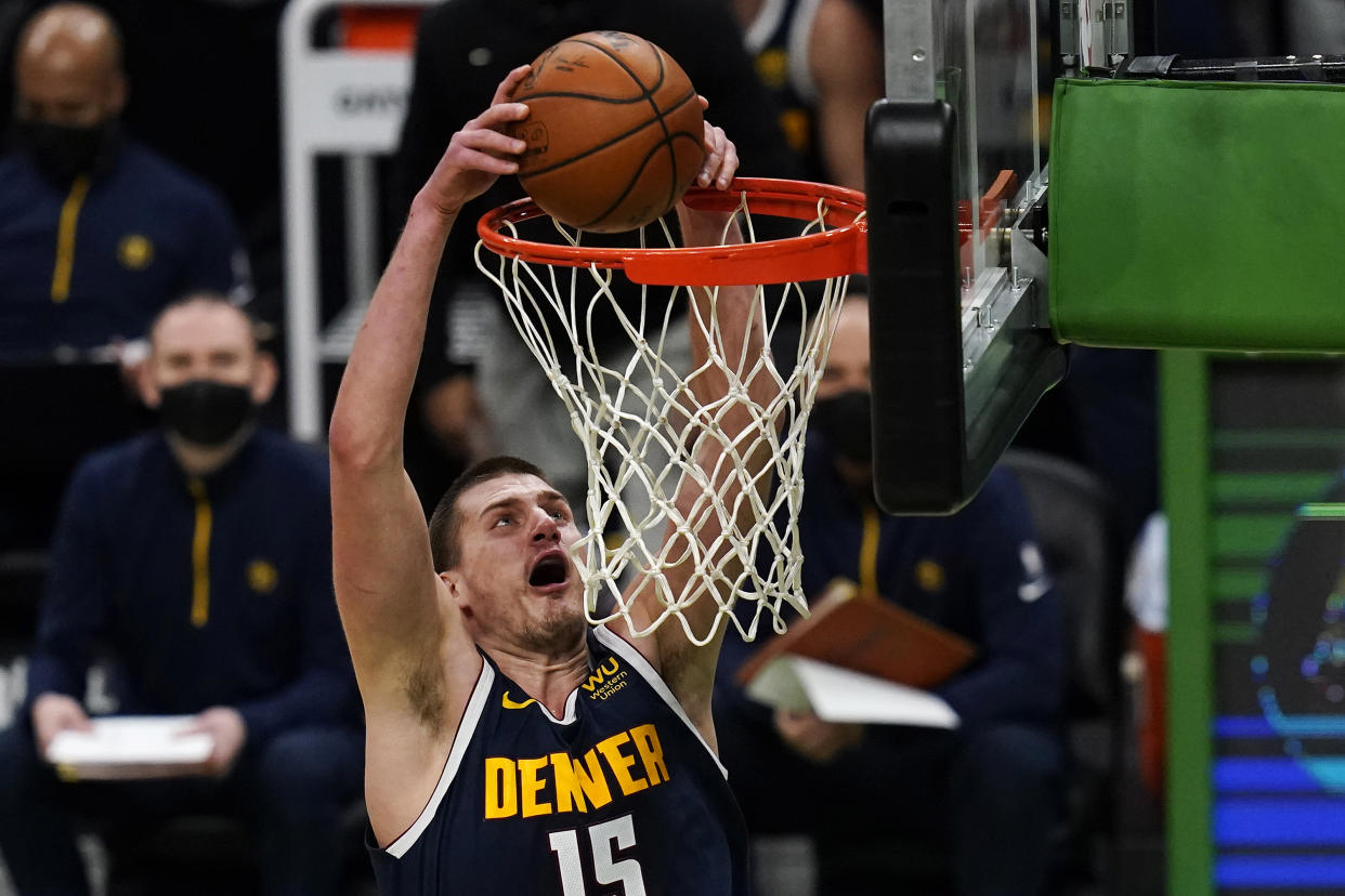 Nikola Jokic dunks with two hands.