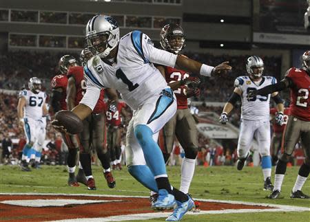 Oct 24, 2013; Tampa, FL, USA; Carolina Panthers quarterback Cam Newton (1) runs the ball in for a touchdown during the second half against the Tampa Bay Buccaneers at Raymond James Stadium. Kim Klement-USA TODAY Sports