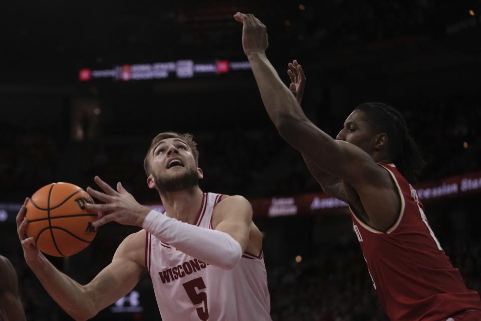 Wisconsin's Tyler Wahl shoots past Maryland's Julian Reese during the second half of an NCAA college basketball game Tuesday, Feb. 20, 2024, in Madison, Wis. (AP Photo/Morry Gash)