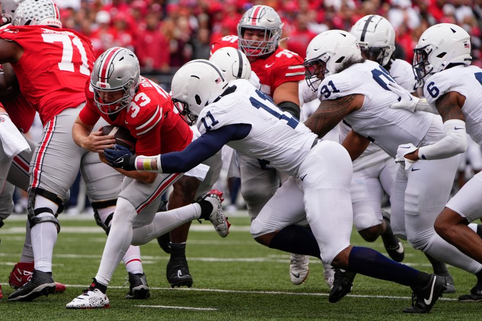 Oct 21, 2023; Columbus, Ohio, USA; Ohio State Buckeyes quarterback Devin Brown (33) runs toward the goal line and Penn State Nittany Lions linebacker Abdul Carter (11) during the second half of the NCAA football game at Ohio Stadium. Brown was stopped short and injured on the play. Ohio State won 20-12.