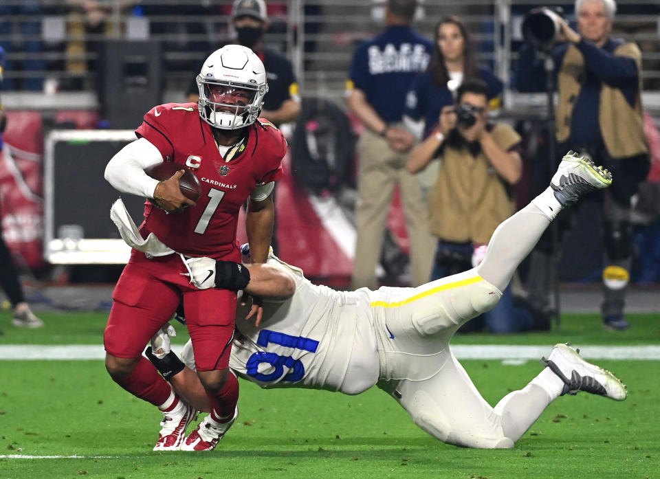 Kyler Murray of the Arizona Cardinals is tackled by Greg Gaines of the Los Angeles Rams. (Photo by Norm Hall/Getty Images)