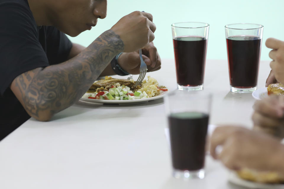 A young man who was imprisoned for belonging to a gang eats his lunch at the Vida Libre” or “free life,” rehabilitation center, in Santa Ana, El Salvador, Saturday, April 29, 2023. Vida Libre, a church program founded by American pastor Kenton Moody, takes in minors who are nearing the end of their prison sentence and have demonstrated good conduct. (AP Photo/Salvador Melendez)