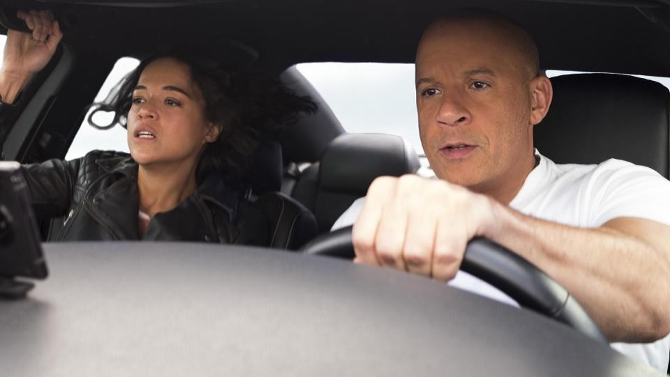 Michelle Rodriguez holds on for dear life as Vin Diesel drives a car real fast in F9.