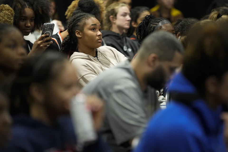 Darianna Alexander, center, listens during a seminar at the NCAA College Basketball Academy, Saturday, July 29, 2023 in Memphis, Tenn. The transfer portal and Name, Image and Likeness (NIL) rules that have engulfed college sports have further complicated the already confusing recruiting process for thousands of teenagers. (AP Photo/George Walker IV)