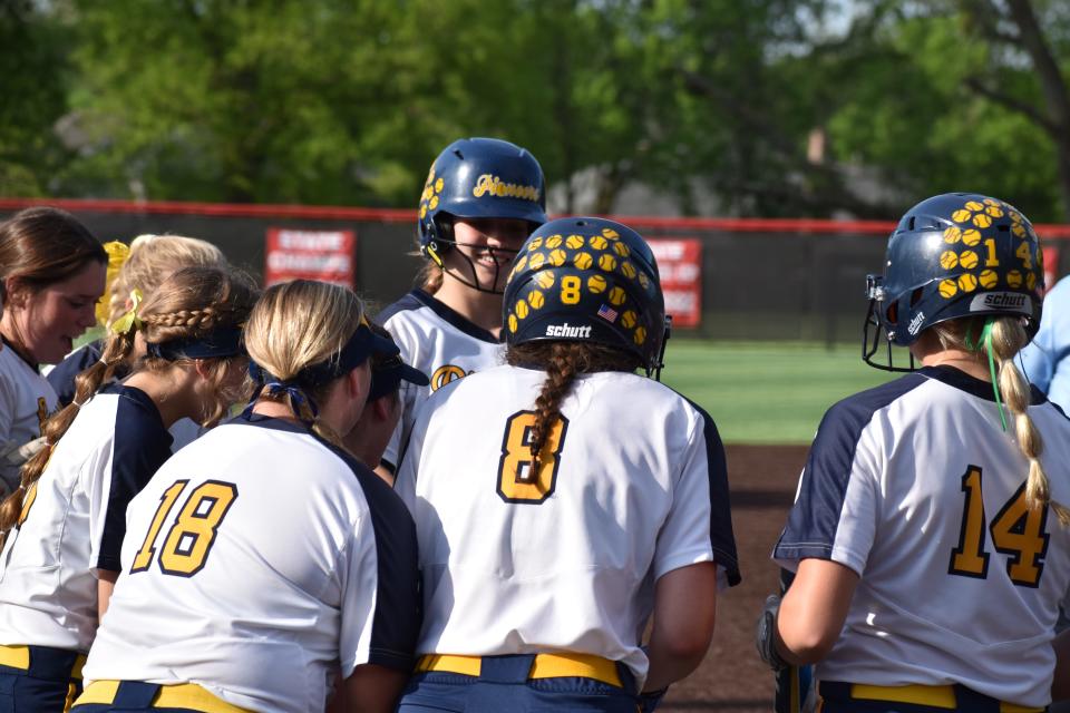 Mooresville's Alex Cooper walks to home plate as teammates congratulate her after hitting a home run during the Pioneers' game with Center Grove on May 12, 2022.