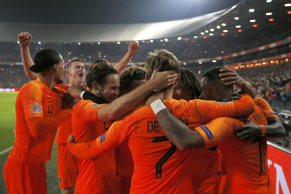 Netherlands players celebrate scoring 2-0 during the international friendly soccer match between The Netherlands and France at De Kuip stadium in Rotterdam, Netherlands, Friday, Nov. 16, 2018. (AP Photo/Peter Dejong)