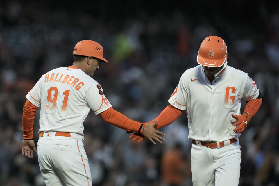 San Francisco Giants' Patrick Bailey, right, celebrates with third base coach Mark Hallberg after hitting a two-run home run against the Cincinnati Reds during the third inning of a baseball game Tuesday, Aug. 29, 2023, in San Francisco. (AP Photo/Godofredo A. Vásquez)